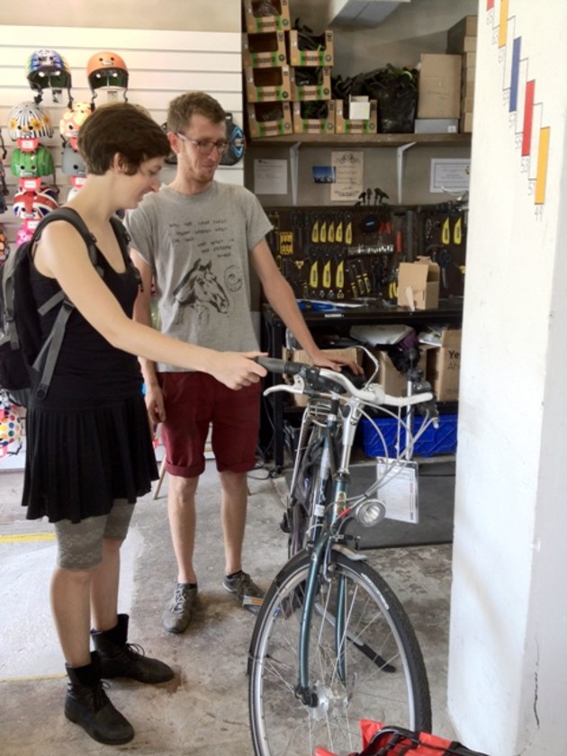 Ollie explains the features of this second hand Dutch bike to an interested customer.